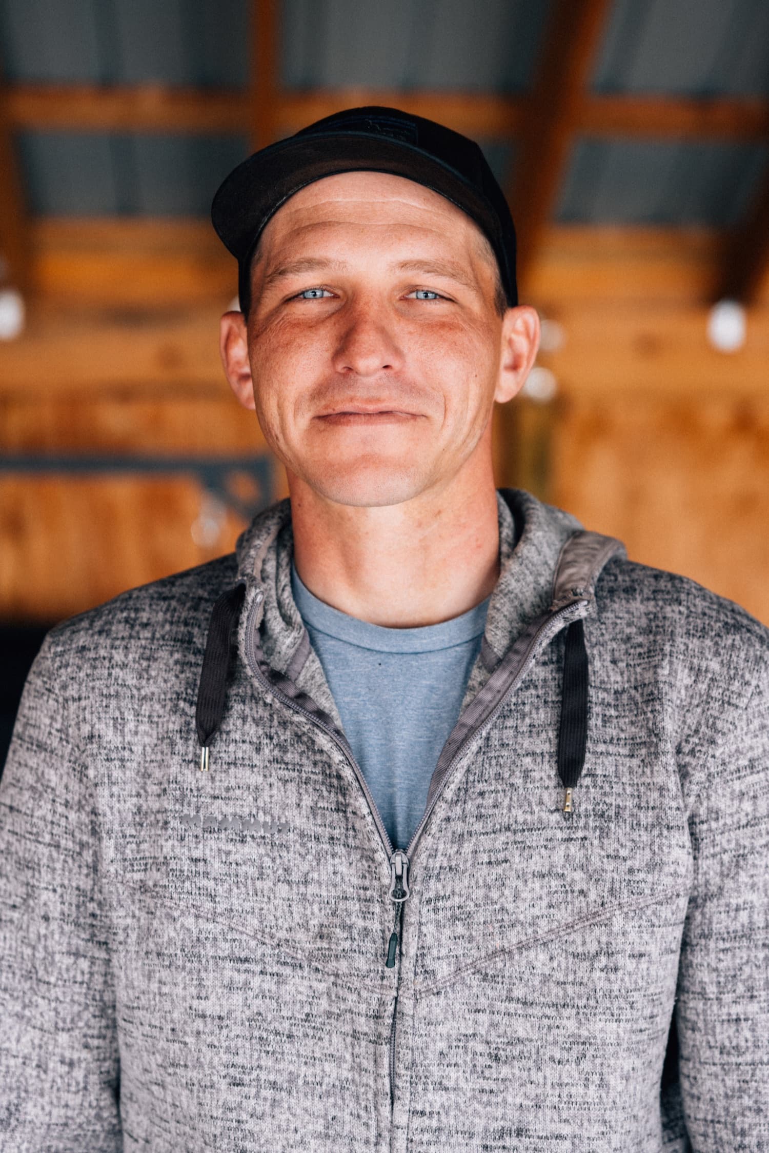 Sam, co-founder of Gardens of Fire, standing in the barn